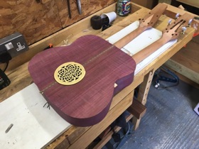 A rear soundhole allows access the inside.